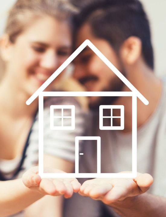 Young couple holding their new, dream home in hands